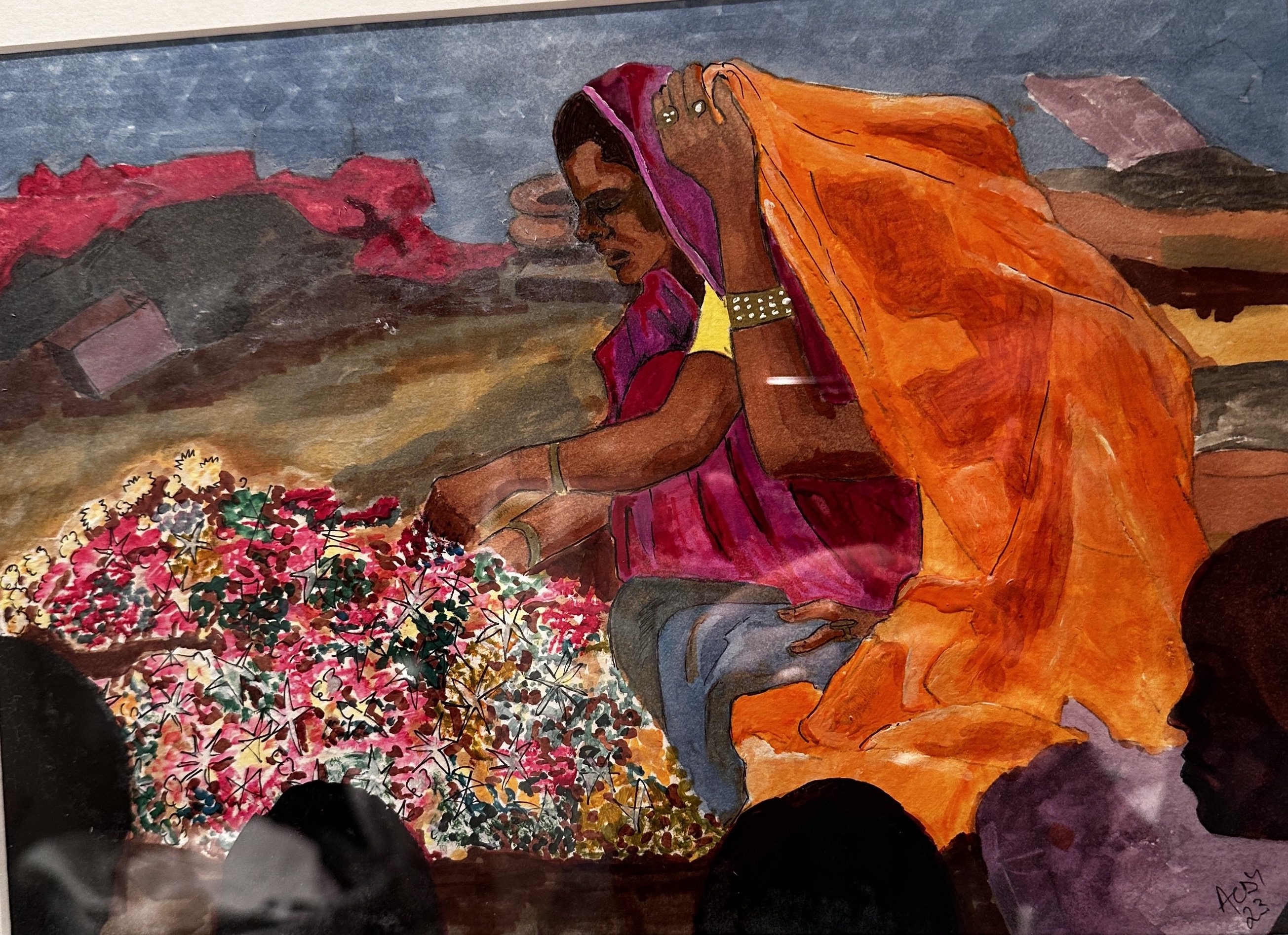 Woman in vibrant saree arranging colorful flowers at an outdoor event.