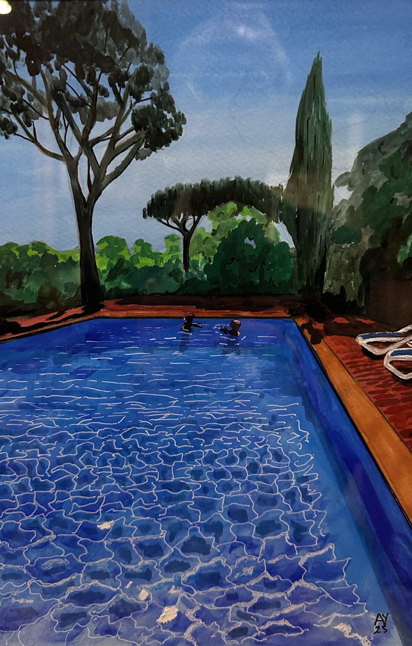 Two people swimming in a serene blue pool surrounded by trees and lounge chairs.
