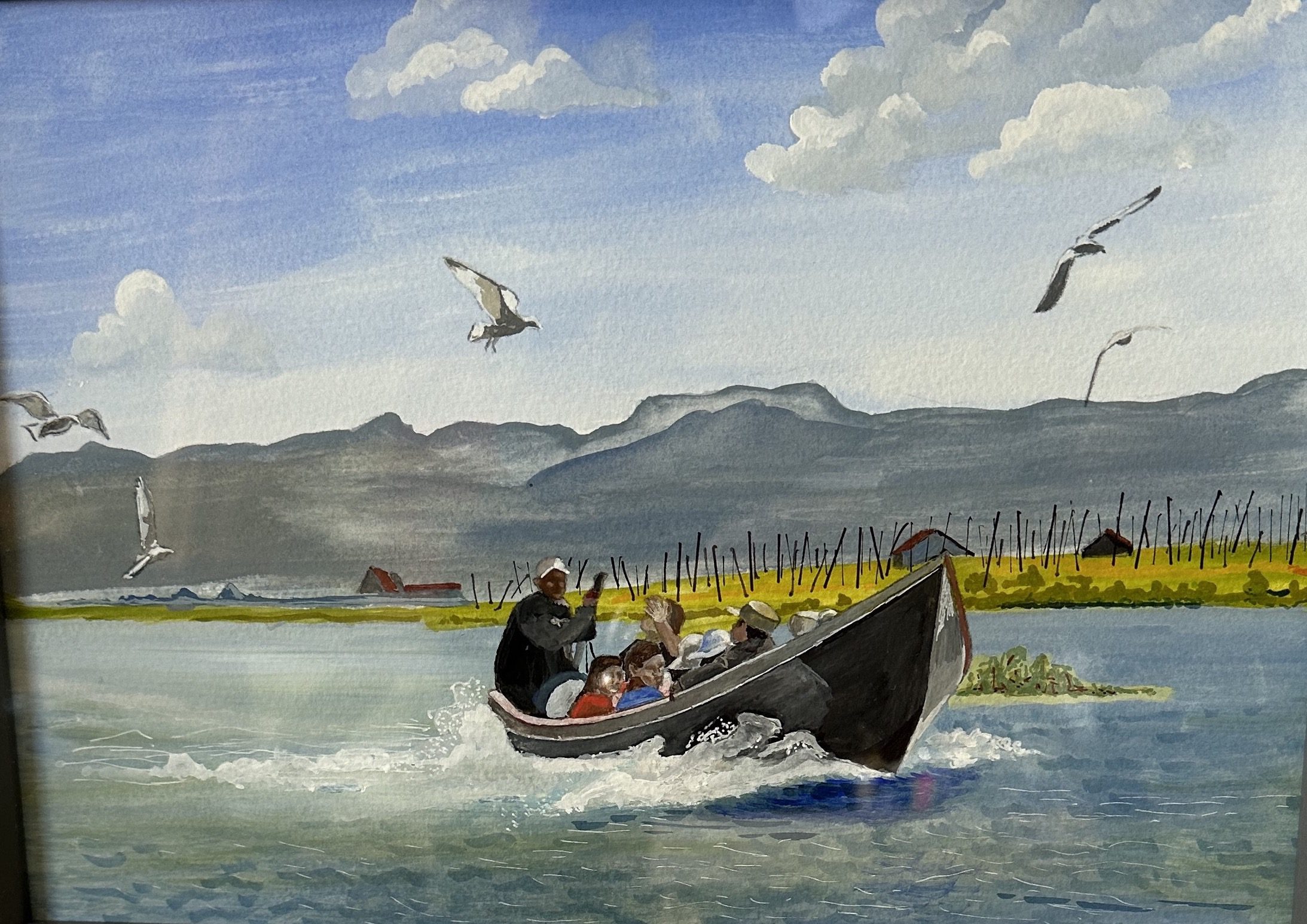 A person rides a motorboat with seagulls flying nearby on a sunny day.