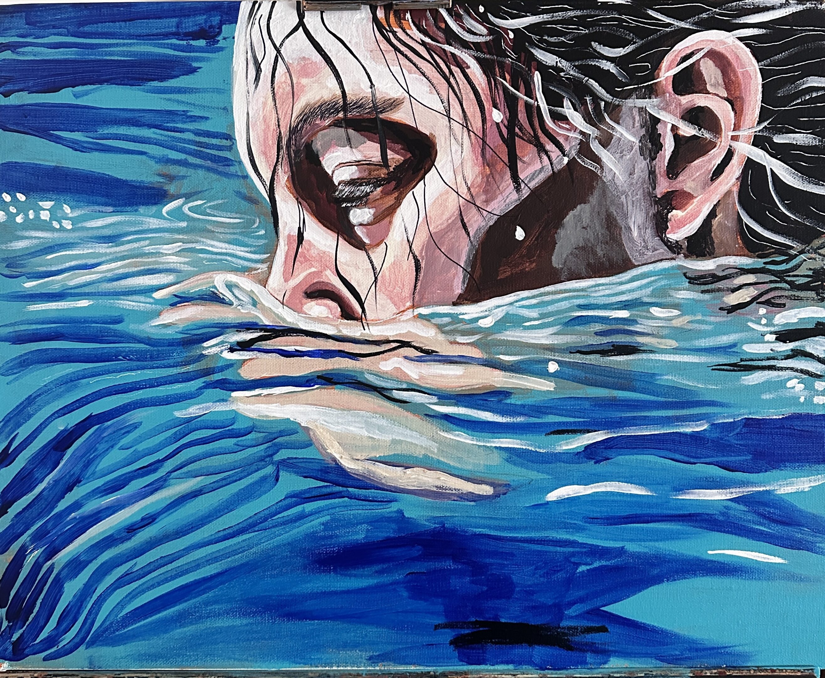A person partially submerged in water with intense expression.