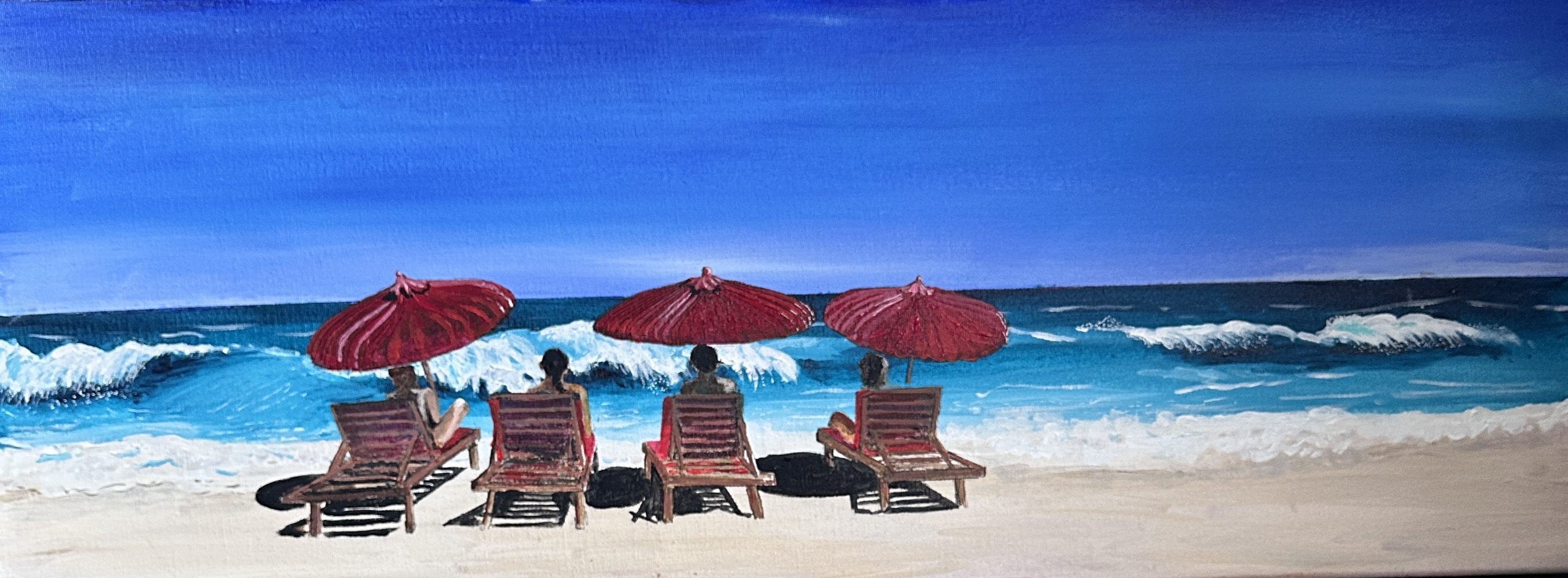 Four red umbrellas and lounge chairs on a beach by the blue ocean.